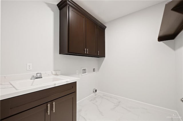 laundry room with cabinet space, baseboards, hookup for a washing machine, marble finish floor, and a sink