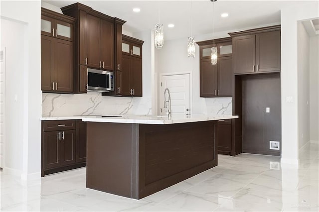 2608 Linva Ave, Edinburg, TX 78541 - kitchen featuring stainless steel microwave, backsplash, light countertops, dark brown cabinets, and recessed lighting