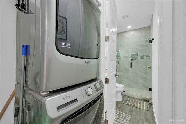 1320 S Cesar Chavez Rd, Edinburg, TX 78542 - full bathroom featuring stacked washer / dryer, a stall shower, wood finished floors, and recessed lighting