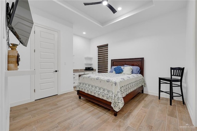 1320 S Cesar Chavez Rd, Edinburg, TX 78542 - bedroom with light wood-style flooring, a tray ceiling, recessed lighting, and ceiling fan