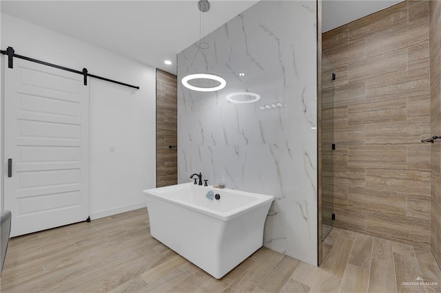 1320 S Cesar Chavez Rd, Edinburg, TX 78542 - bathroom with tiled shower, recessed lighting, a freestanding bath, and wood finished floors