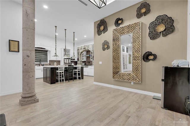 1320 S Cesar Chavez Rd, Edinburg, TX 78542 - living room featuring ornate columns, light wood-style floors, and recessed lighting