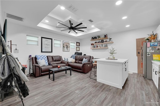 1320 S Cesar Chavez Rd, Edinburg, TX 78542 - living area with ceiling fan, recessed lighting, light wood-style floors, a tray ceiling, and plenty of natural light
