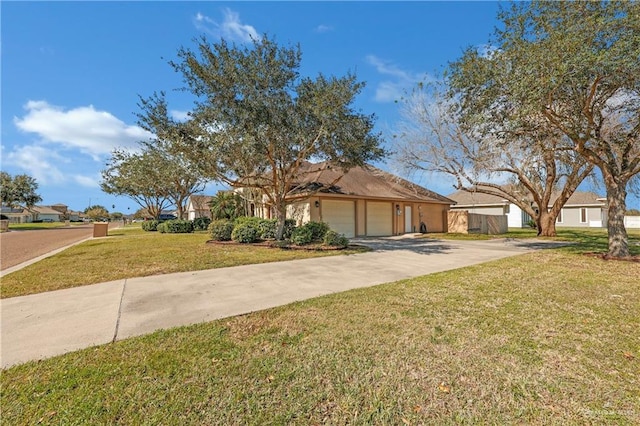 view of front of home featuring an attached garage, concrete driveway, and a front yard