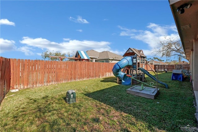 view of play area with a fenced backyard and a yard