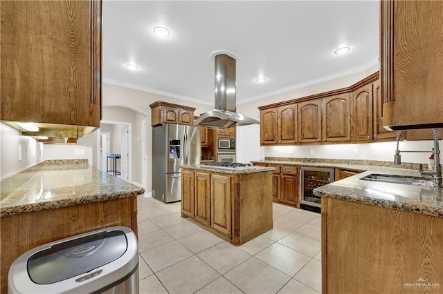 kitchen featuring beverage cooler, a kitchen island, appliances with stainless steel finishes, island exhaust hood, and a sink