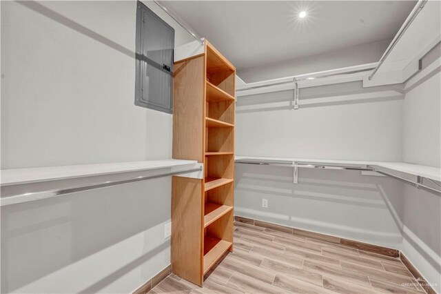 spacious closet with wood finish floors and electric panel