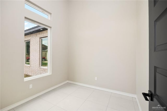 spare room featuring light tile patterned floors