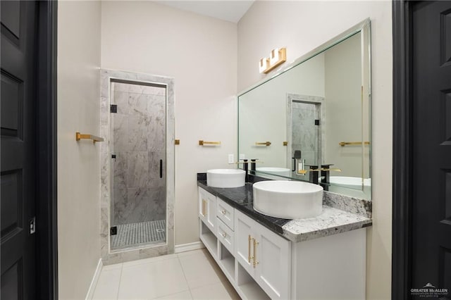 bathroom featuring a shower with door, vanity, and tile patterned floors