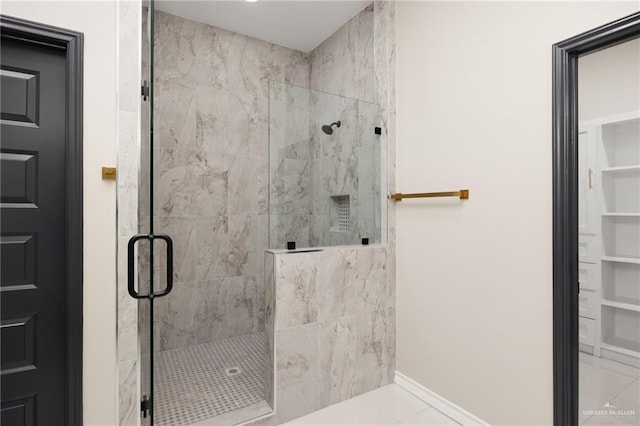 bathroom with tile patterned flooring and a shower with shower door