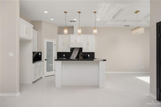 kitchen featuring white cabinetry, light tile patterned floors, pendant lighting, and backsplash