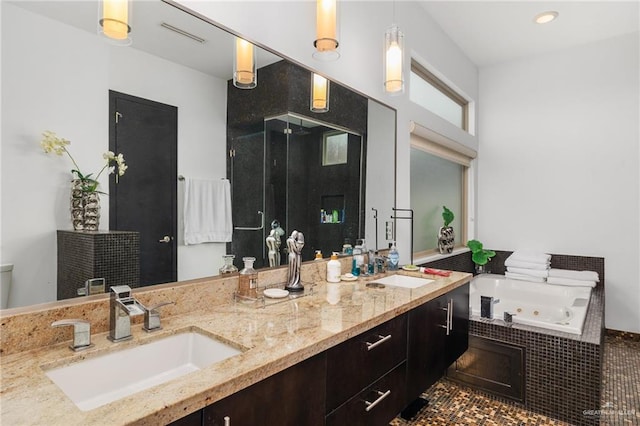 bathroom with vanity and tiled tub