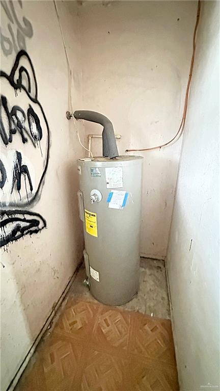 utility room featuring electric water heater