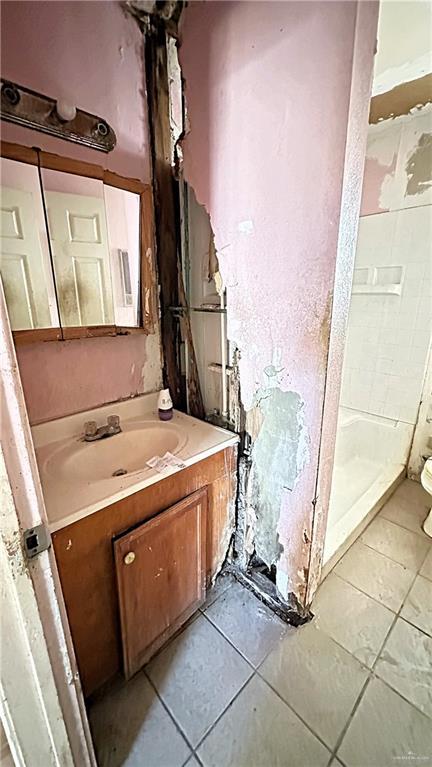 bathroom with a shower, tile patterned flooring, vanity, and toilet