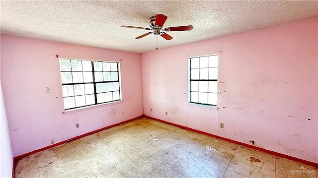 spare room featuring ceiling fan and a textured ceiling