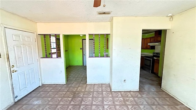 unfurnished room featuring ceiling fan and a textured ceiling