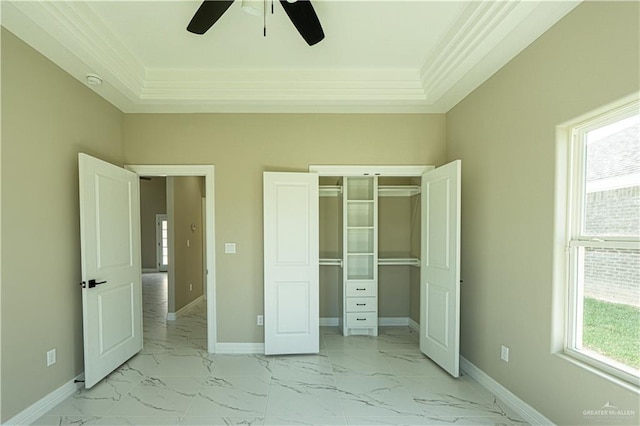 unfurnished bedroom featuring marble finish floor, baseboards, and a closet