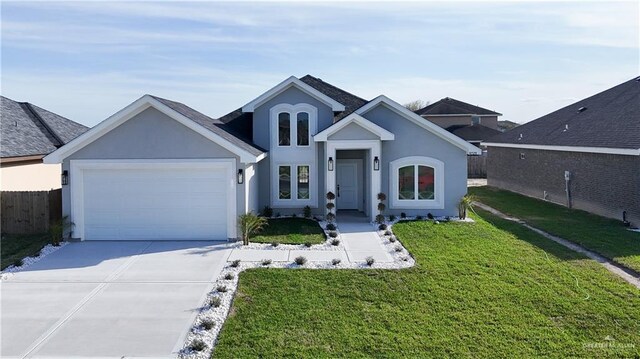 view of front of house featuring a front yard, concrete driveway, an attached garage, and stucco siding