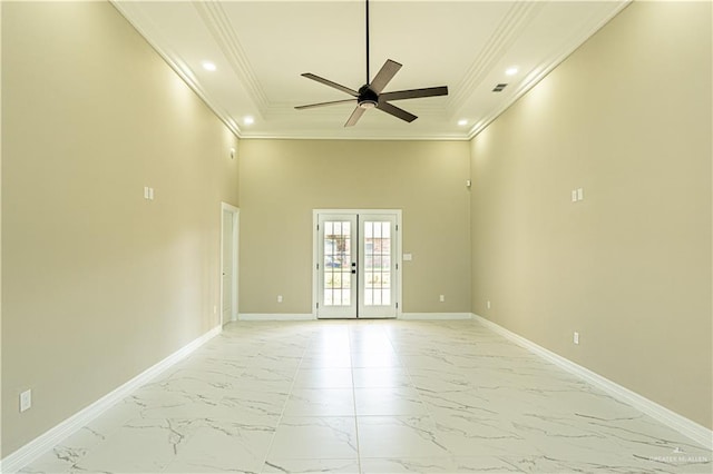 spare room with marble finish floor, baseboards, and french doors