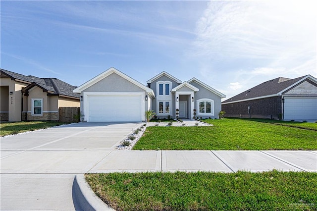 view of front of house featuring driveway, a garage, a front yard, and stucco siding