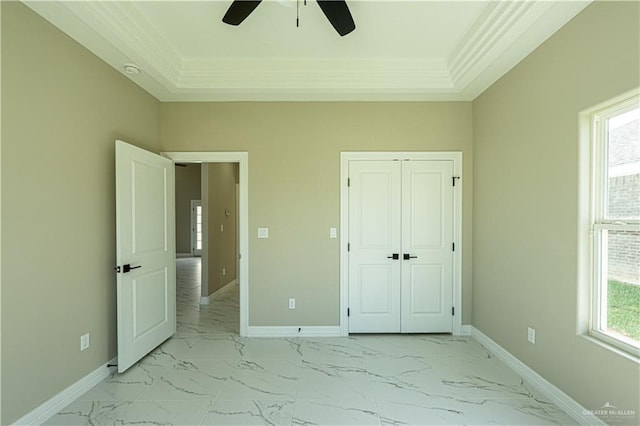 unfurnished bedroom featuring marble finish floor, multiple windows, and baseboards