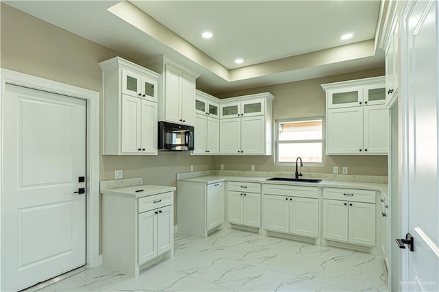 kitchen featuring glass insert cabinets, black microwave, a sink, and marble finish floor