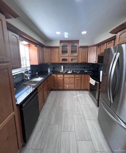 kitchen featuring sink, stainless steel appliances, and tasteful backsplash