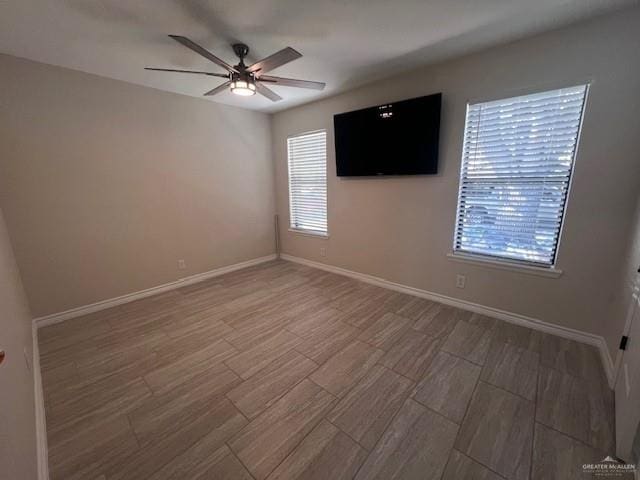 unfurnished room featuring hardwood / wood-style floors and ceiling fan