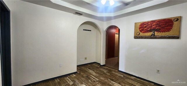117 N Jo Beth St, Alton, TX 78573 - unfurnished room with arched walkways, dark wood-style floors, a raised ceiling, and baseboards
