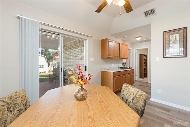 dining space with ceiling fan and light wood-type flooring