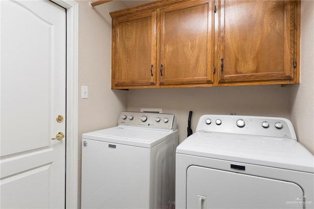 laundry area with cabinets and separate washer and dryer