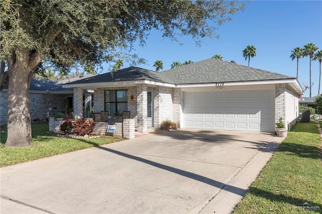 ranch-style home featuring a garage, central air condition unit, and a front yard