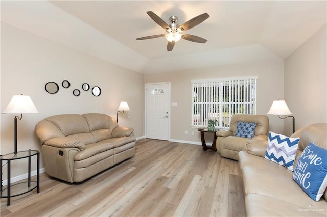 living room with ceiling fan, light wood-type flooring, and vaulted ceiling