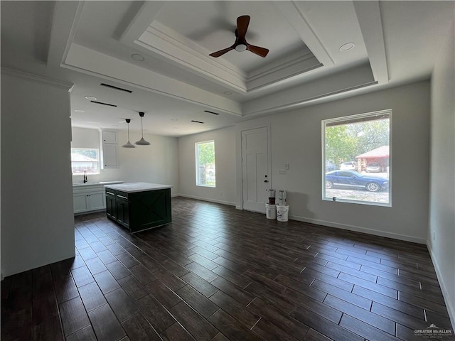 808 E Evans Ave, Pharr, TX 78577 - unfurnished living room with a tray ceiling, ceiling fan, wood tiled floors, crown molding, and a sink