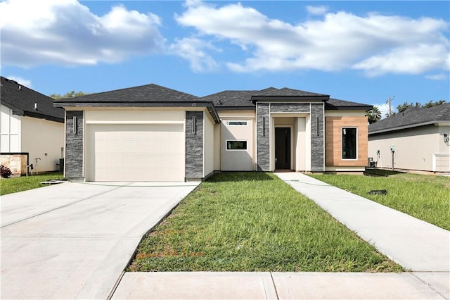 prairie-style home featuring a garage and a front yard