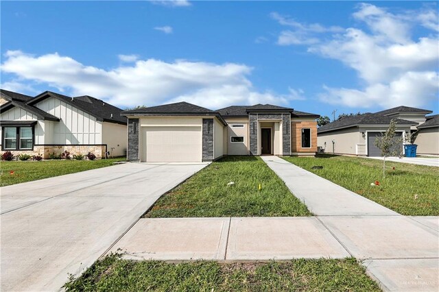 view of front of property with a garage and a front lawn