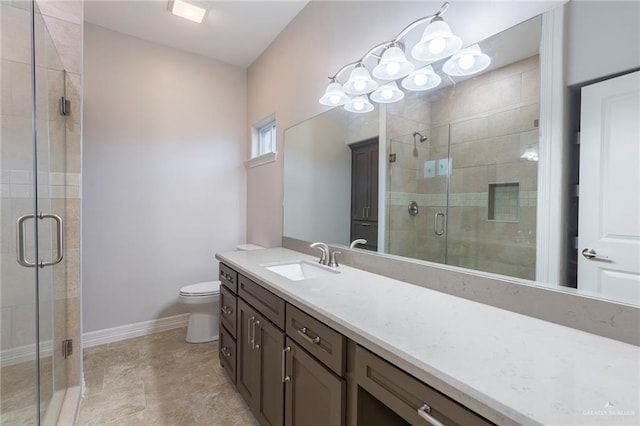 bathroom with a shower with door, vanity, and toilet