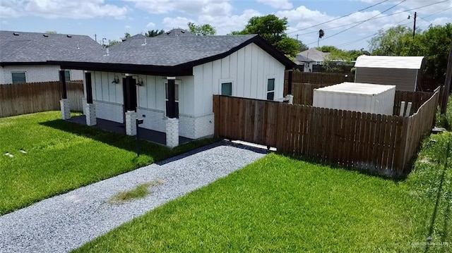 view of side of property with a yard