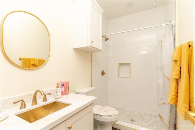 bathroom featuring vanity, toilet, and walk in shower