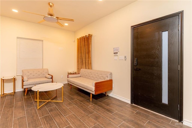 sitting room with dark hardwood / wood-style flooring and ceiling fan