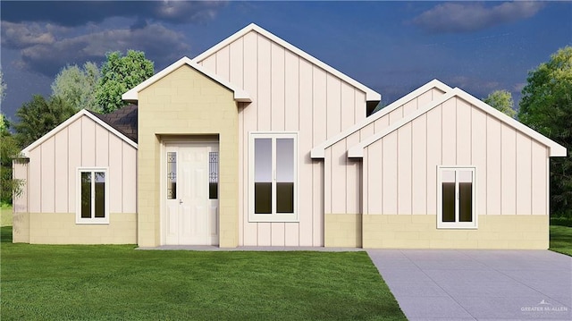 3802 Albanian St, Edinburg, TX 78542 - rear view of property with board and batten siding and a lawn