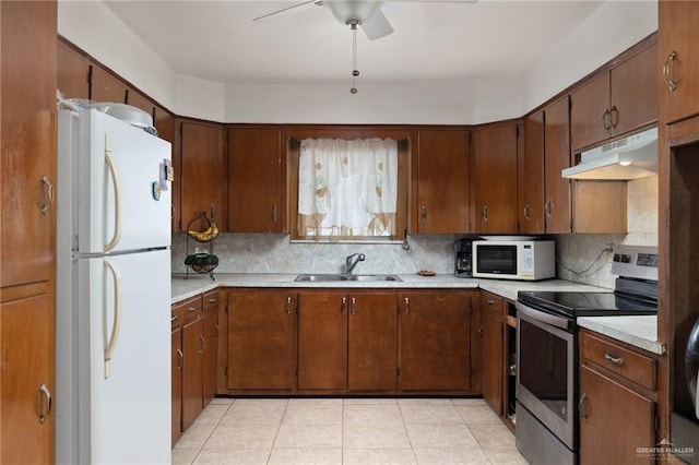 kitchen with light tile patterned flooring, sink, backsplash, ceiling fan, and white appliances