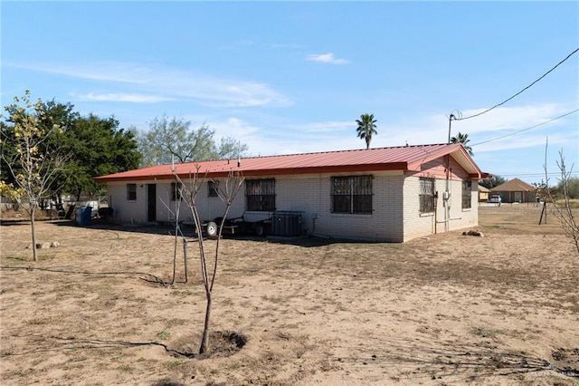 back of house with central AC unit