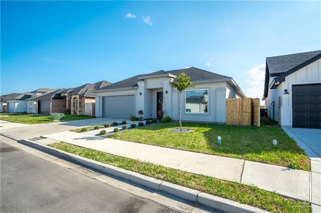 view of front of property with a garage and a front lawn