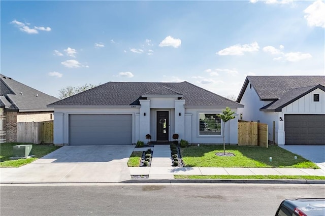 view of front of home featuring a garage and a front lawn