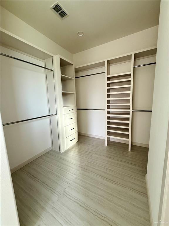 spacious closet with visible vents and wood finished floors