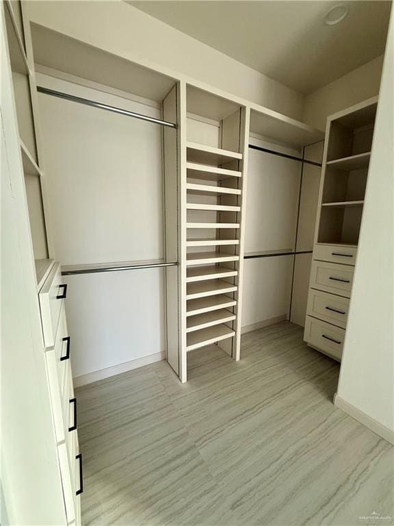 walk in closet featuring light wood-style floors