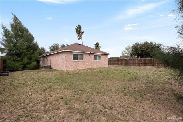 view of yard with cooling unit and fence