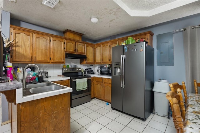 kitchen featuring sink, electric panel, a textured ceiling, light tile patterned floors, and black appliances