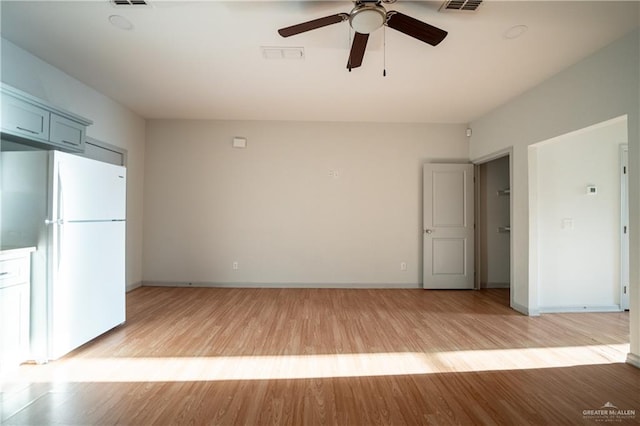 spare room with ceiling fan and light hardwood / wood-style flooring